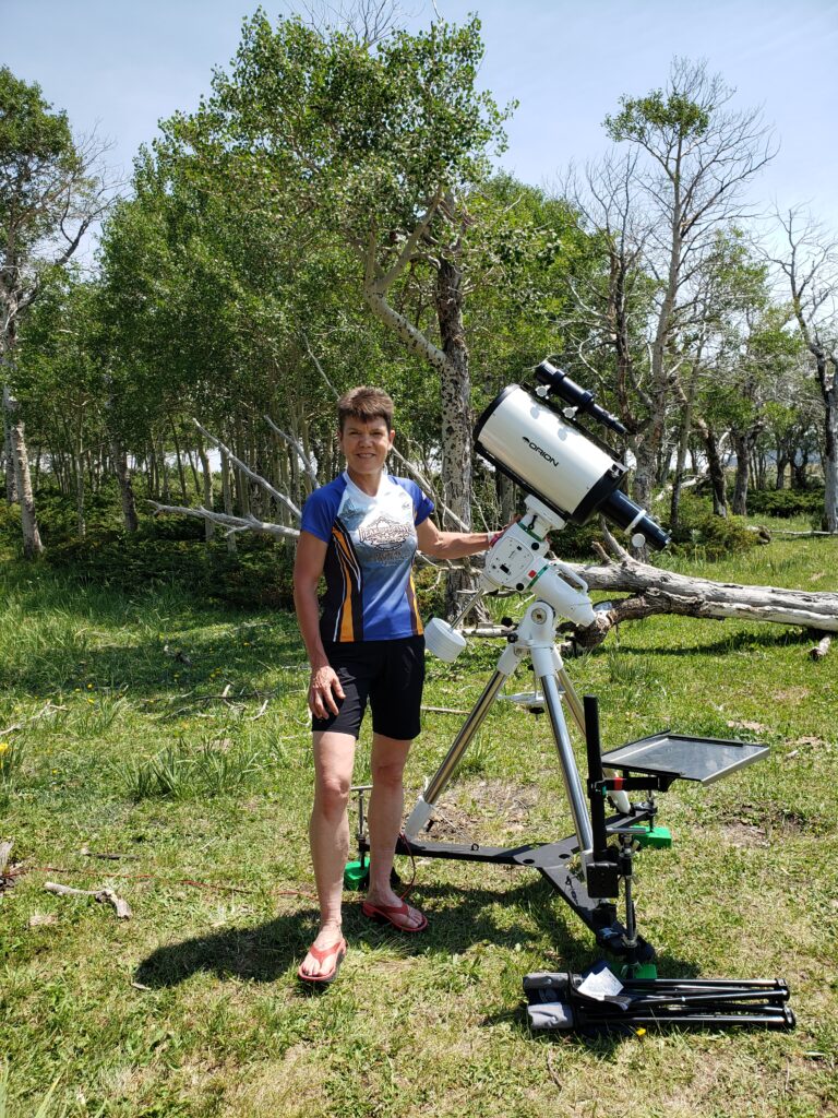 Suzanne Beers with telescope and camera